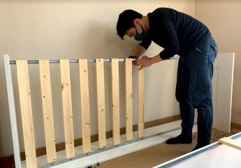 A man building furniture
